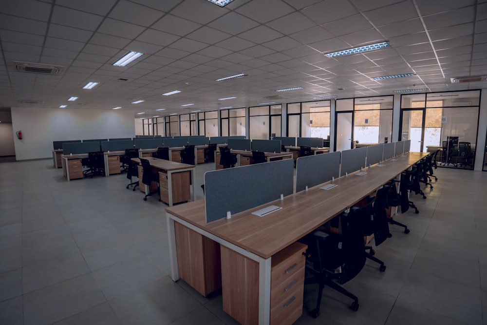 An office space with desks and chairs being cleared out